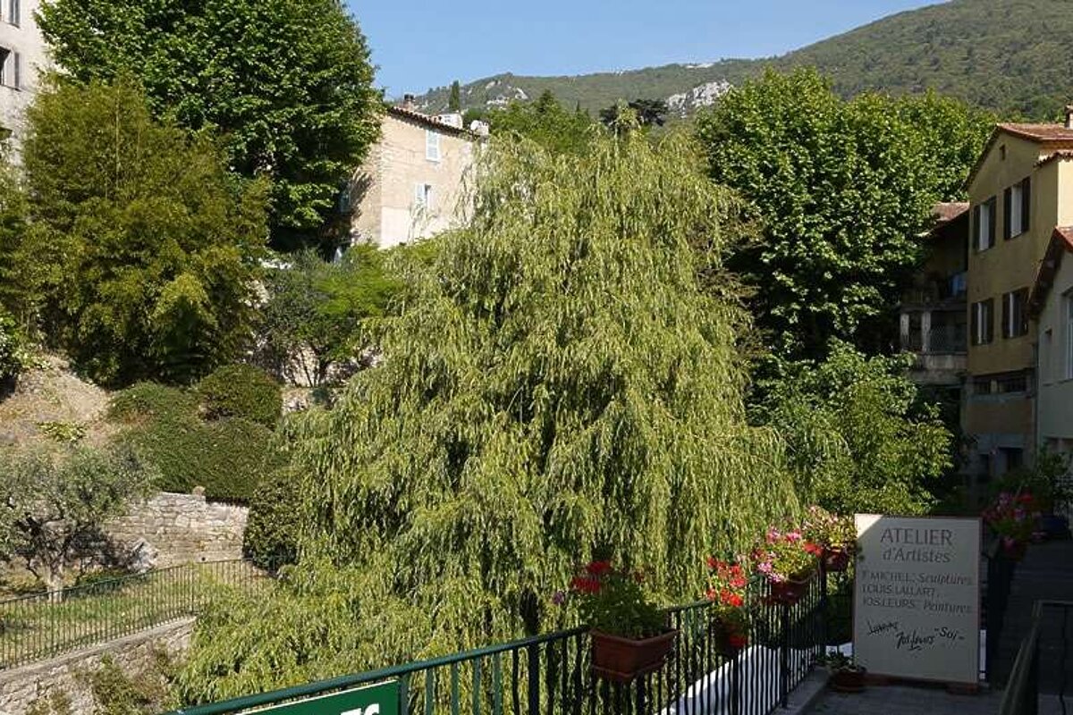 a photo of trees and a small bridge