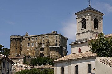 photo of a castle on a hill and a church