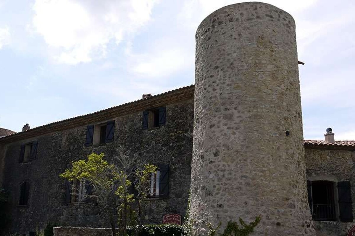 photo of stone house and a tower