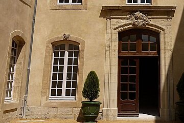 photo of a stone building with wooden door and windows