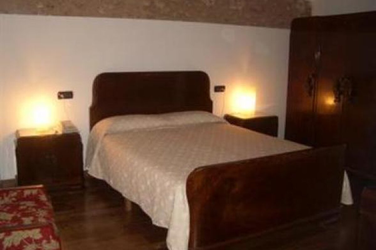 an image of a single bed with dark wood header and footer