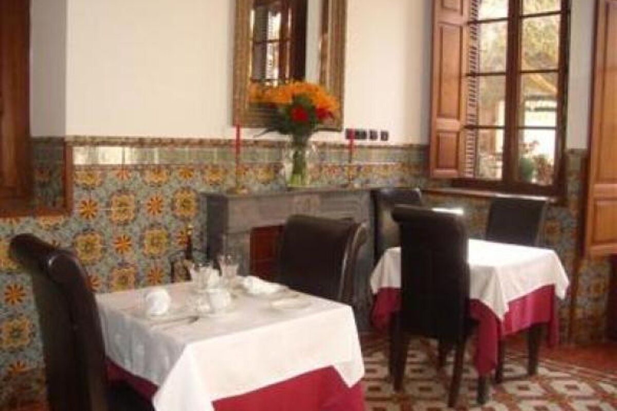 an image of some tables and chairs in a restaurant