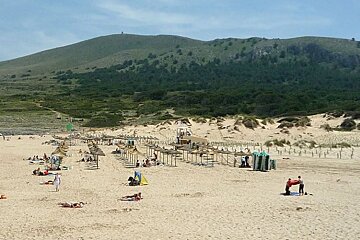 photo of a beach with hills in background