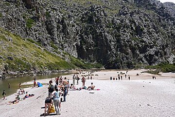 photo of a pebble beach and cliffs