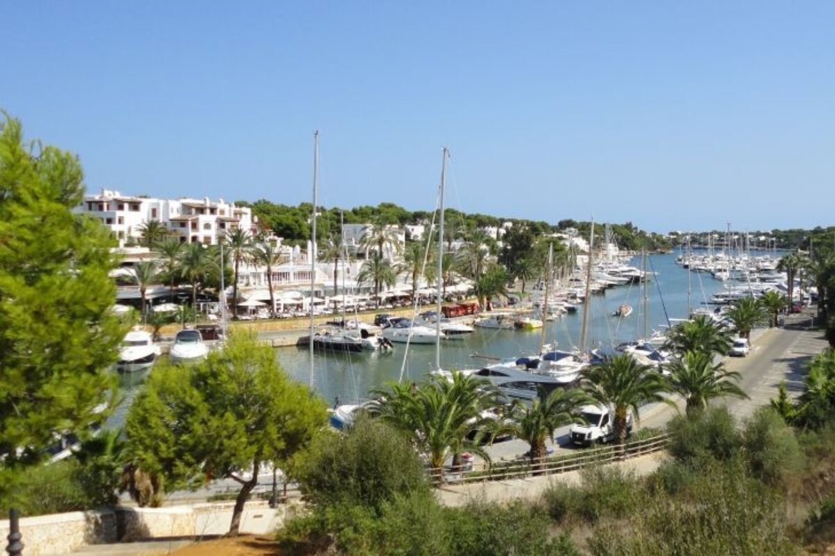 photograph or marina with boats and blue sky