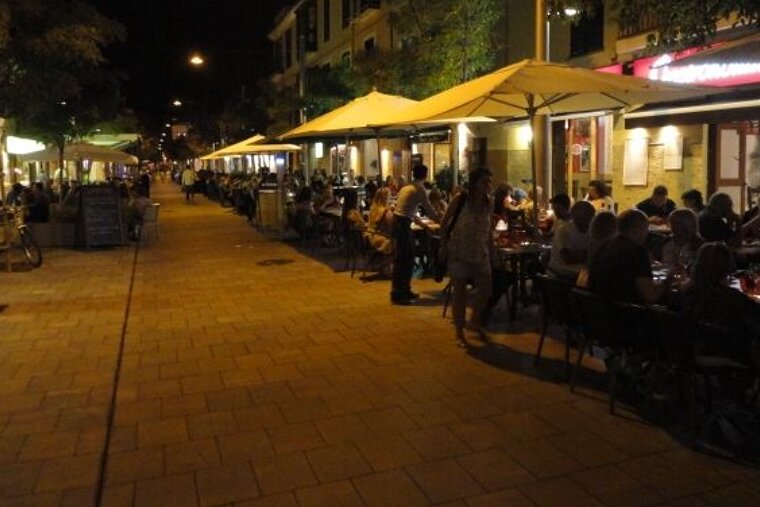 Photo of street with restaurants at night
