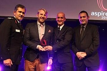 a photo of four men at an awards ceremony