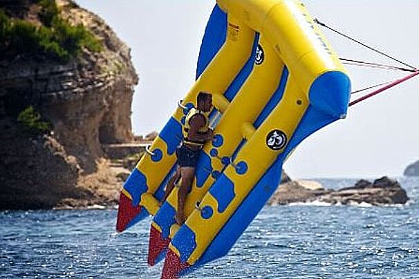 photo of people on a banana boat in the sea