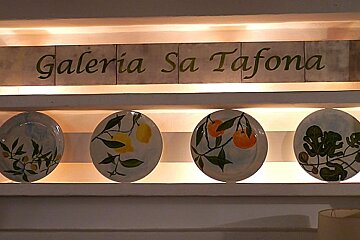 a photo of a sign and decorative plates