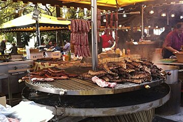 A large grill with lots of meat and sausages on it