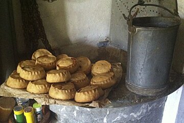 A bunch of pies on a table next to a bucket