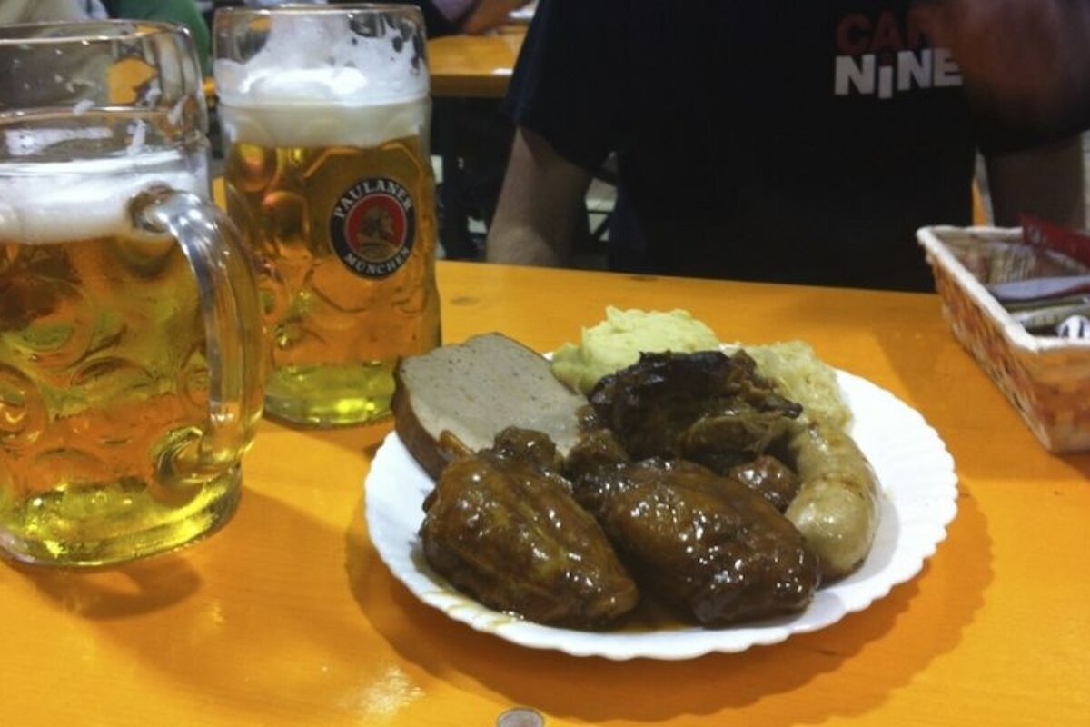 an image of two pints of lager and a plate of food