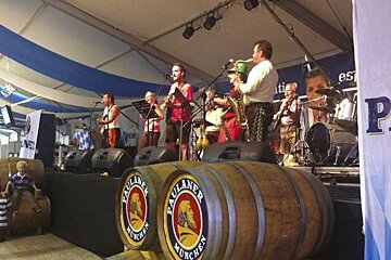 an image of a music band and two barrels of beer