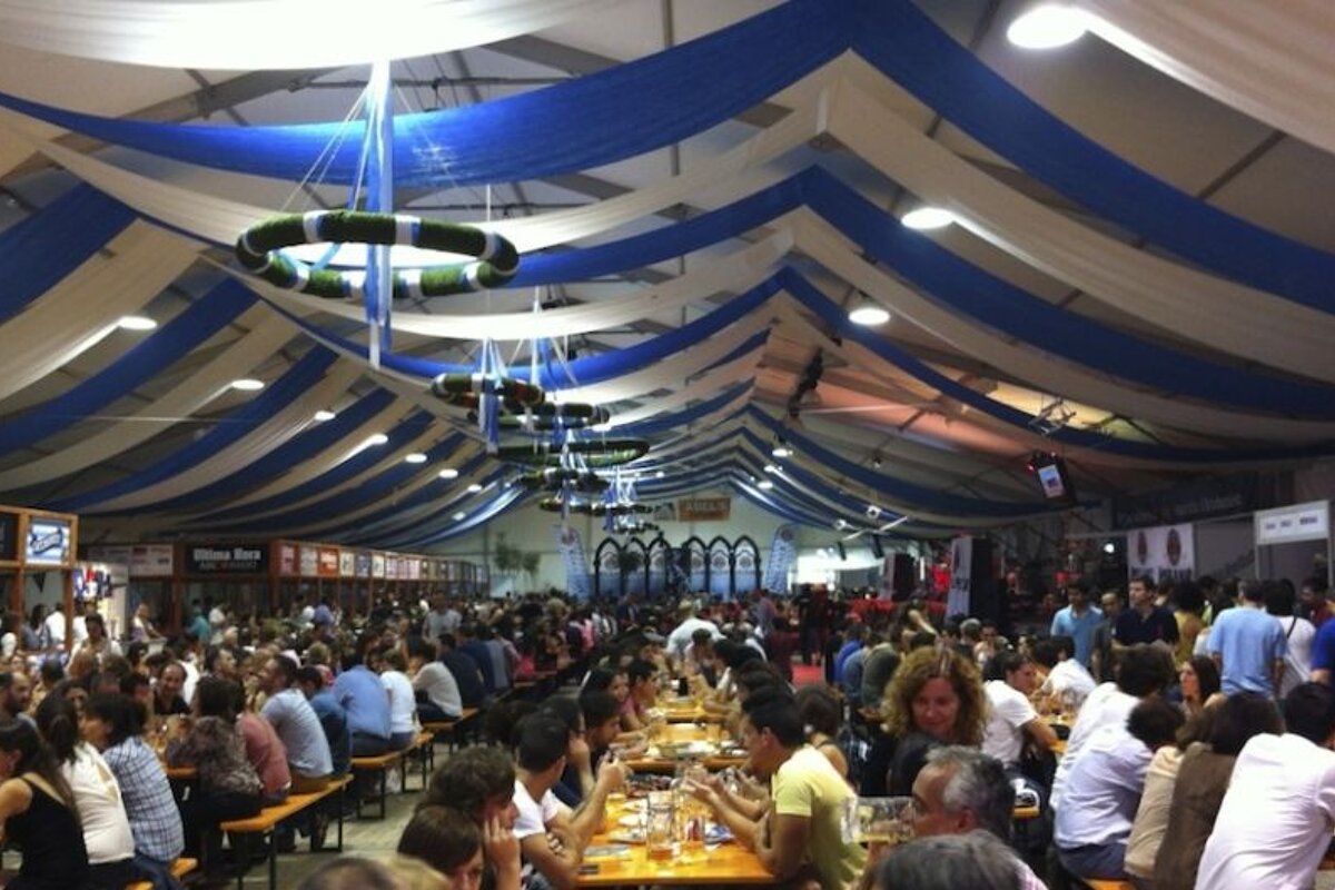an image of a tent interior filled with people and trestle tables