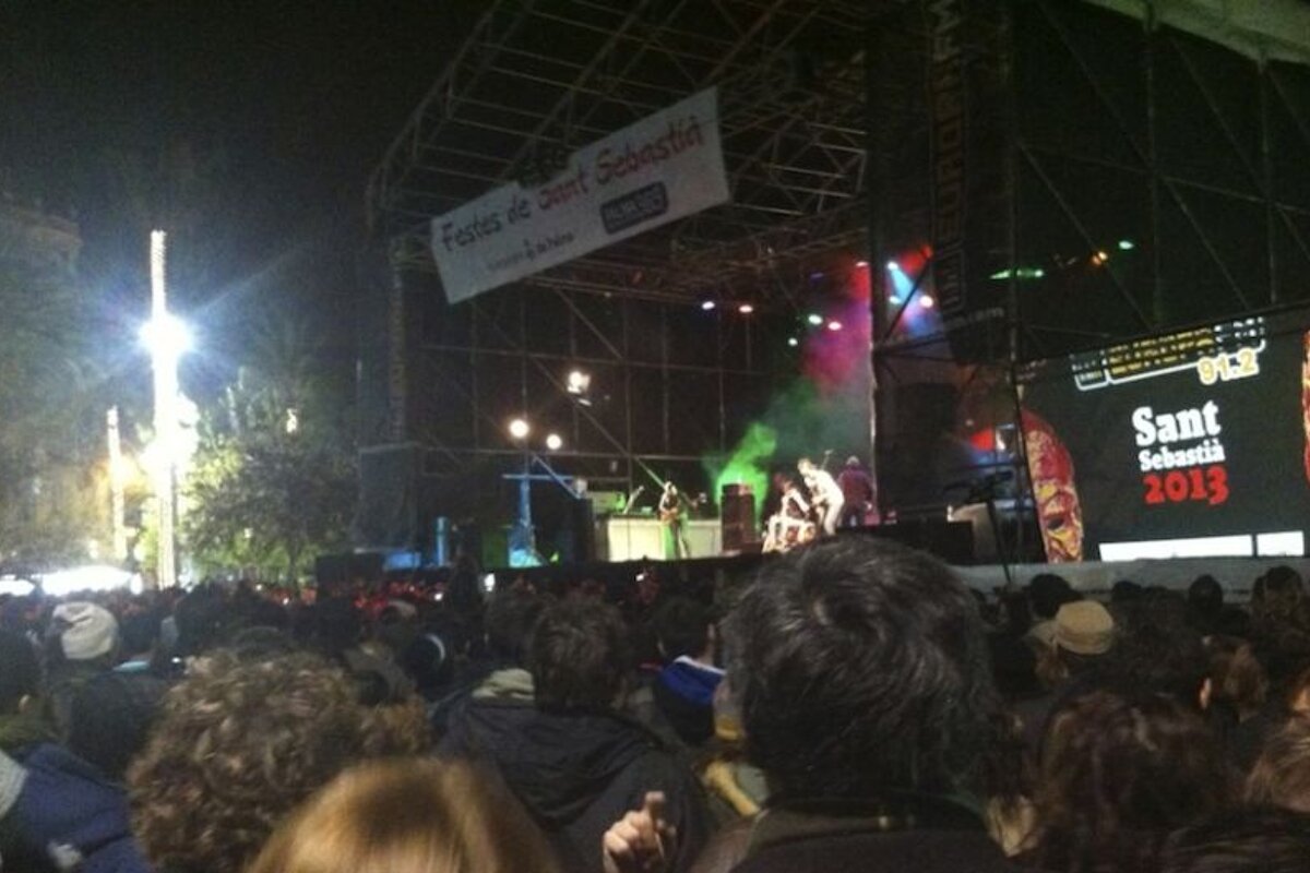 photo of people watching a band on a stage