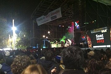 photo of people watching a band on a stage