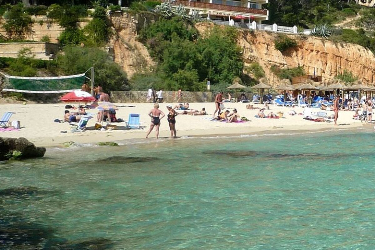 photo of a beach and sea and a volleyball net