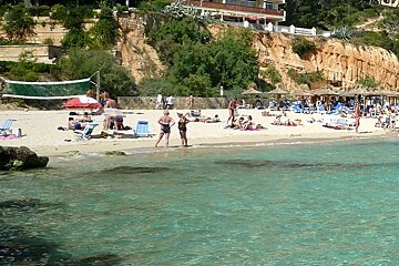 photo of a beach and sea and a volleyball net