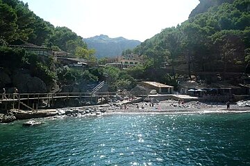 photo of sea and hills