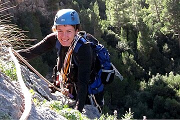 an image of a woman rock climbing