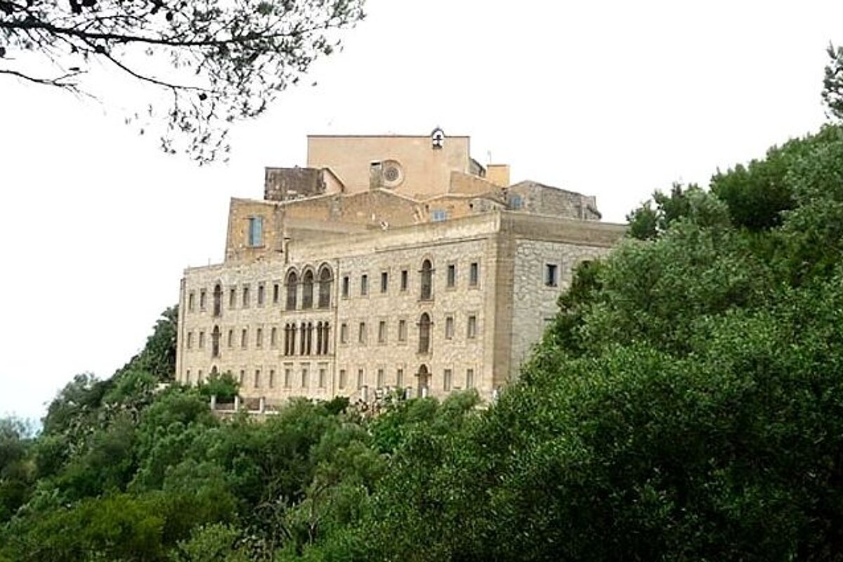 a photo of a large building on top of a hill