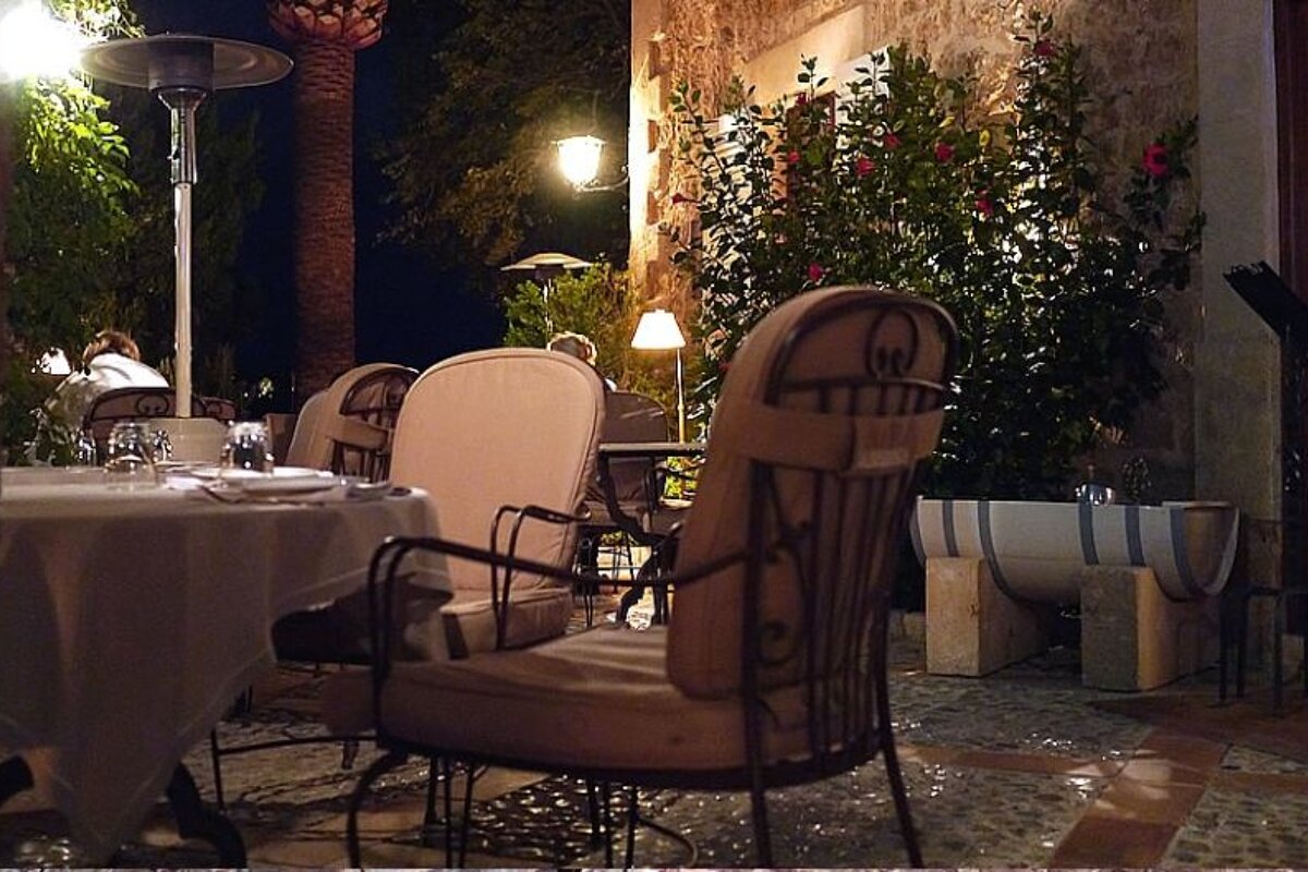 a photo of a dining terrace at night