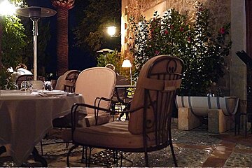 a photo of a dining terrace at night