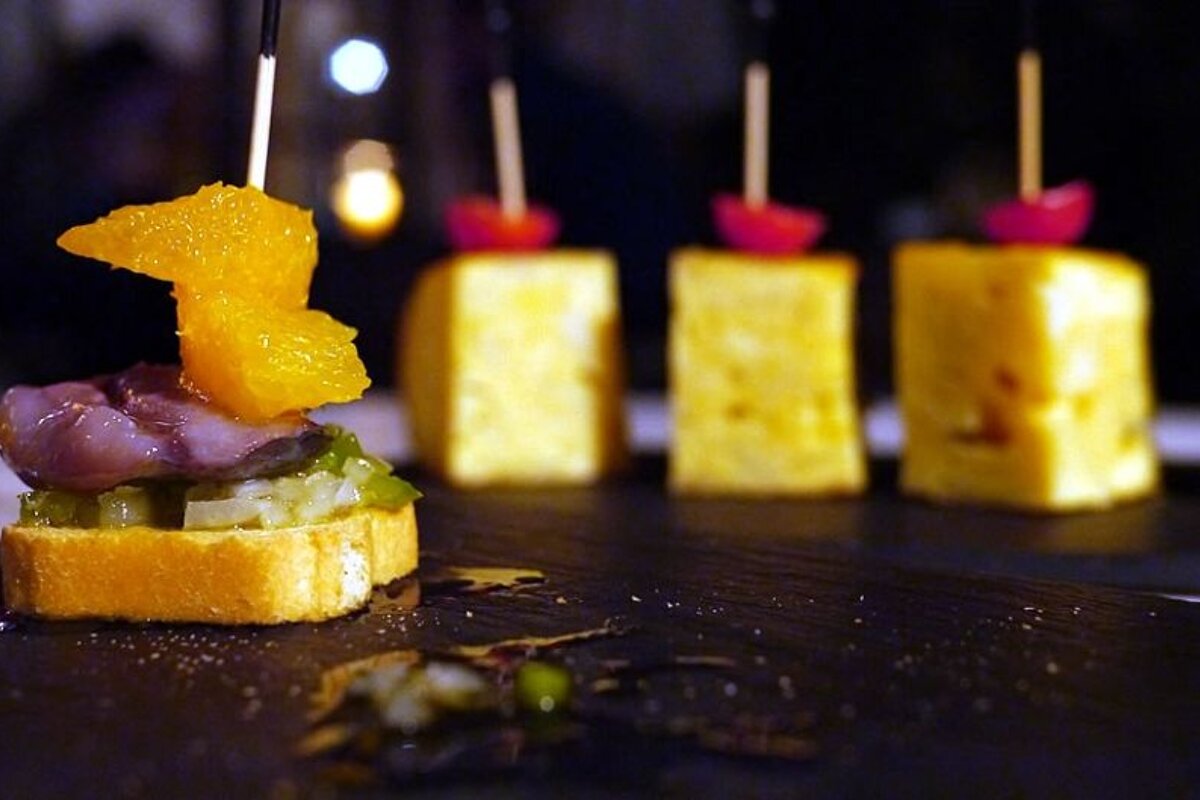 a photo of tapas on a slate plate