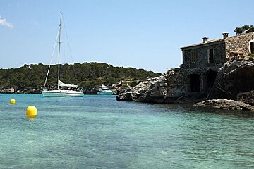 photo of sea and yachts and a cottage