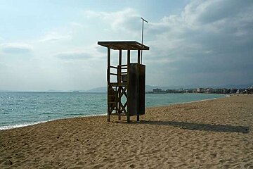 a photo of a watch tower on a sandy beach