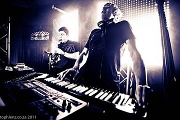 man playing keyboards and saxaphone