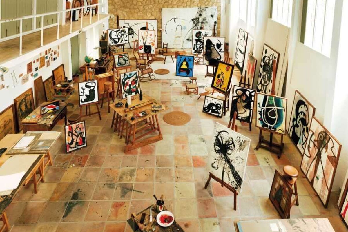 An artist 's studio filled with paintings and easels