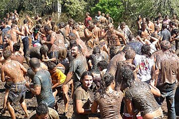 a photo of mallorcans throwing grapes