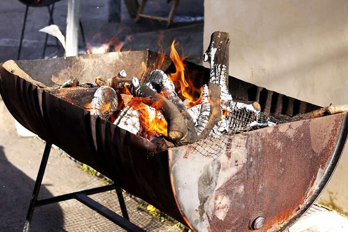 a photo of a fire in a half barrel