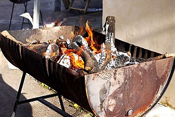 a photo of a fire in a half barrel