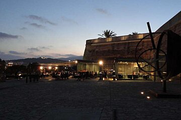Sculpture in foreground of Es Baluard bellver castle in back ground evening
