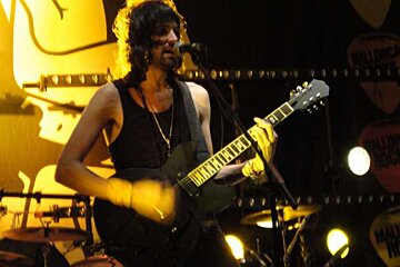 guitar player in black vest