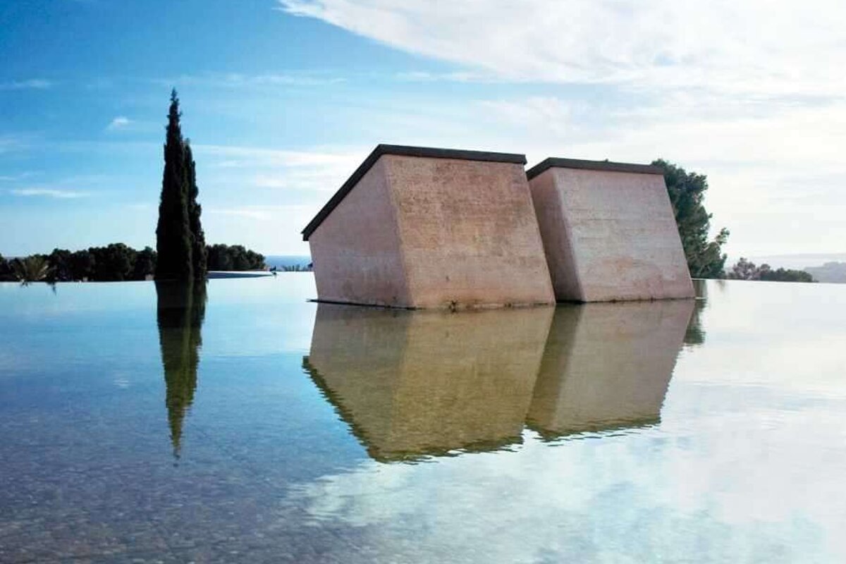 Two buildings are floating in a pool of water
