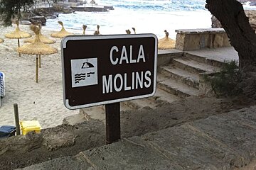 photo of a sign and a beach