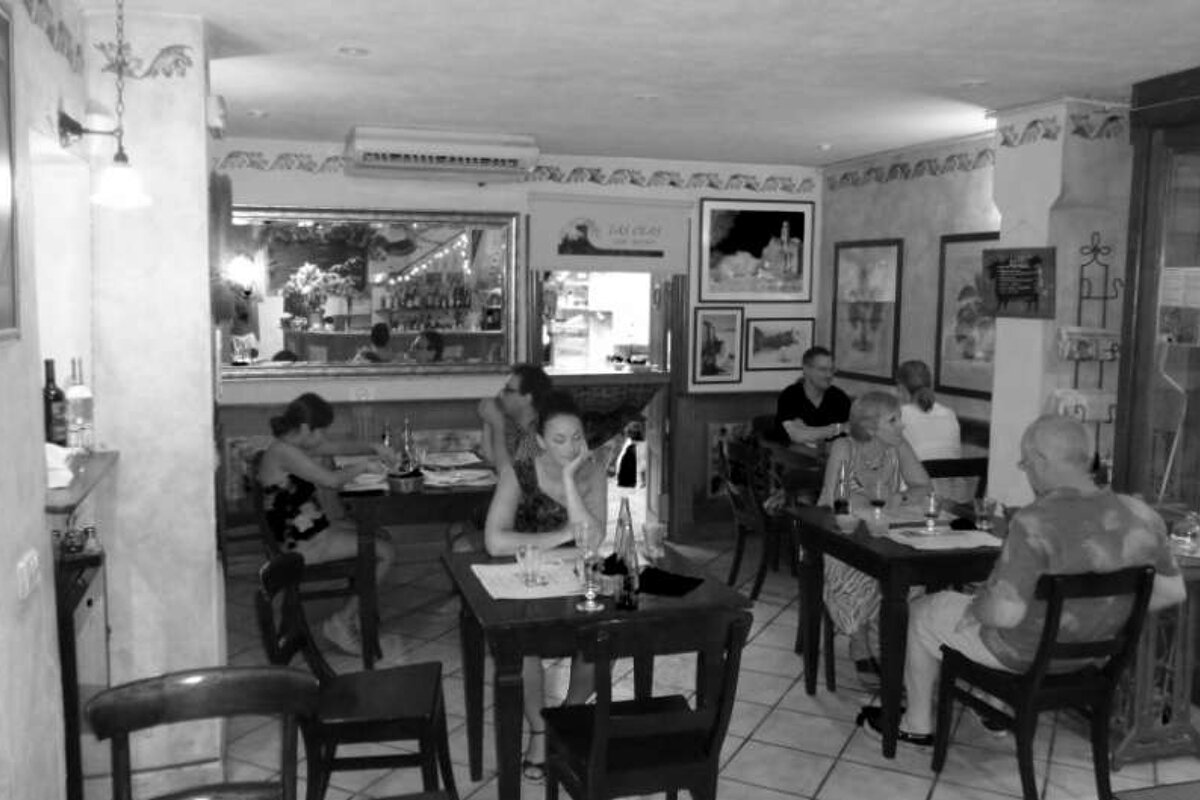 black and white picture of restaurant with people sitting
