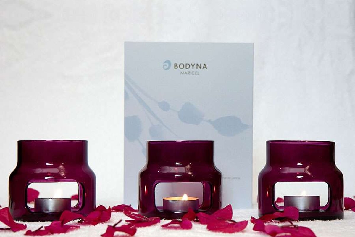 a photo of three candles and a spa menu at the maricel hotel majorca