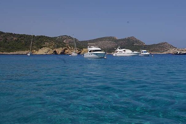 beautiful water and boats infront of island