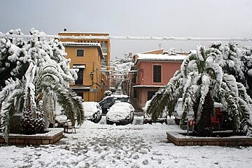 A snowy scene with a police car in the background