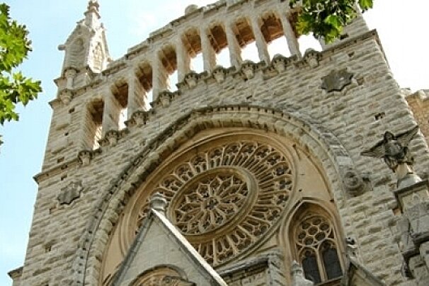 A large brick building with a circular window on the front