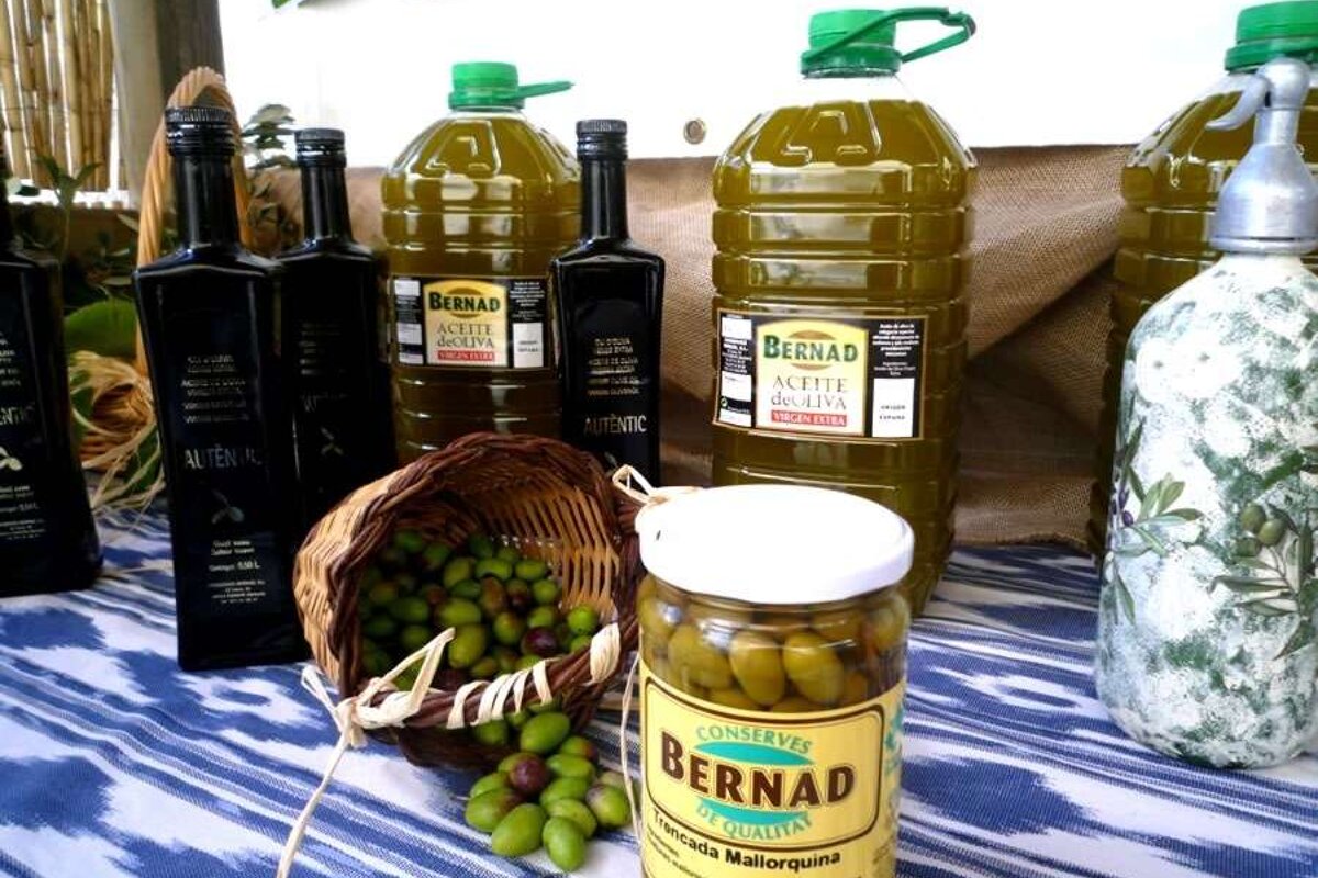 a photo of majorcan olives in a jar and olive oil bottles