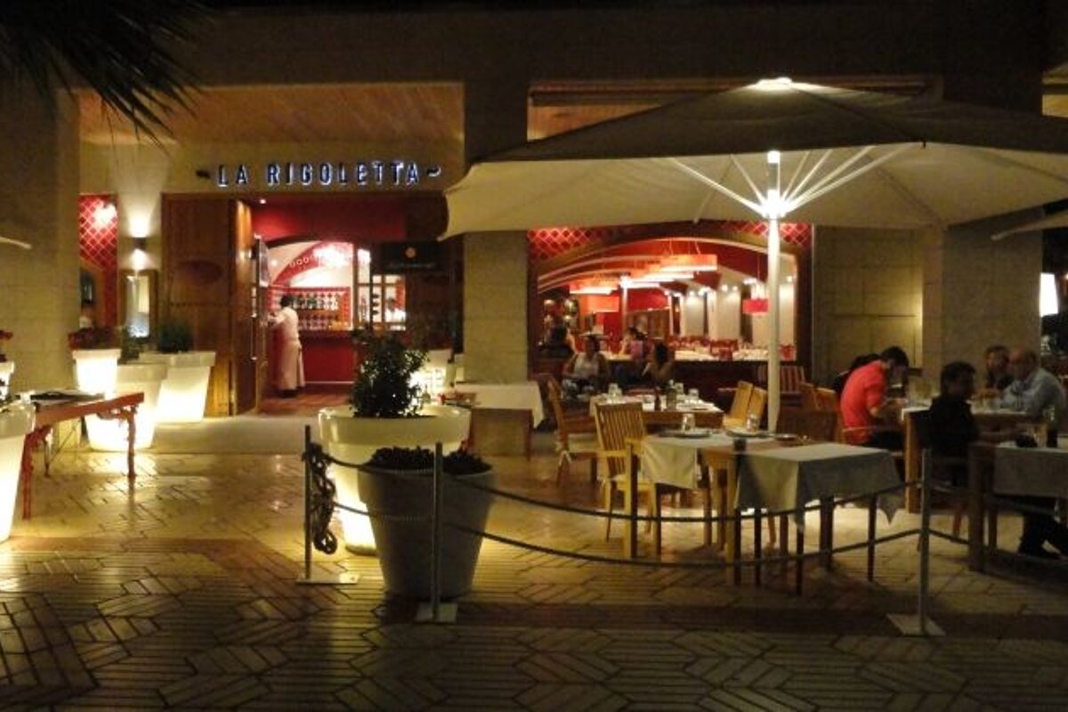outside restaurant area with palm trees night