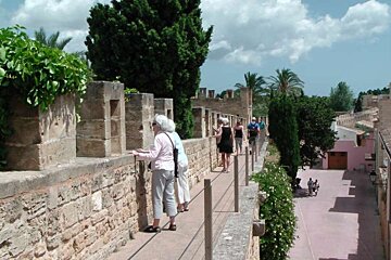 people standing on the walls of alcudia