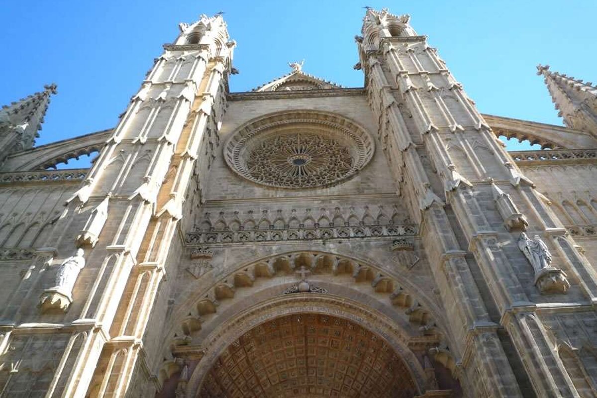 a photo of the front facade of palma cathedral in majorca