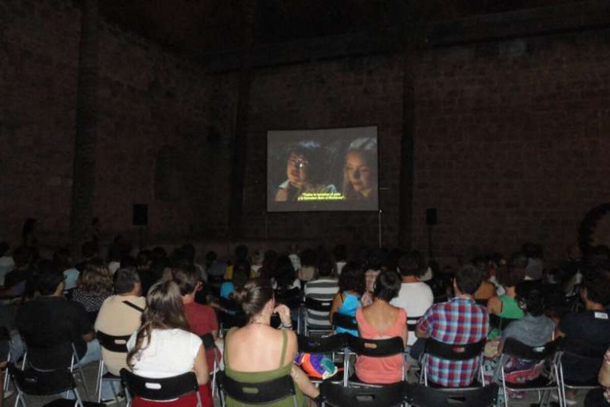 Crowd watching film at night outdoors