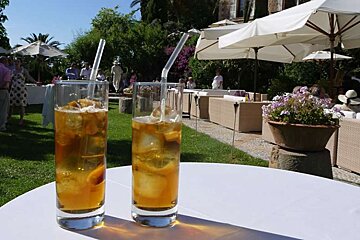 a photo of two glasses of pimms in a garden